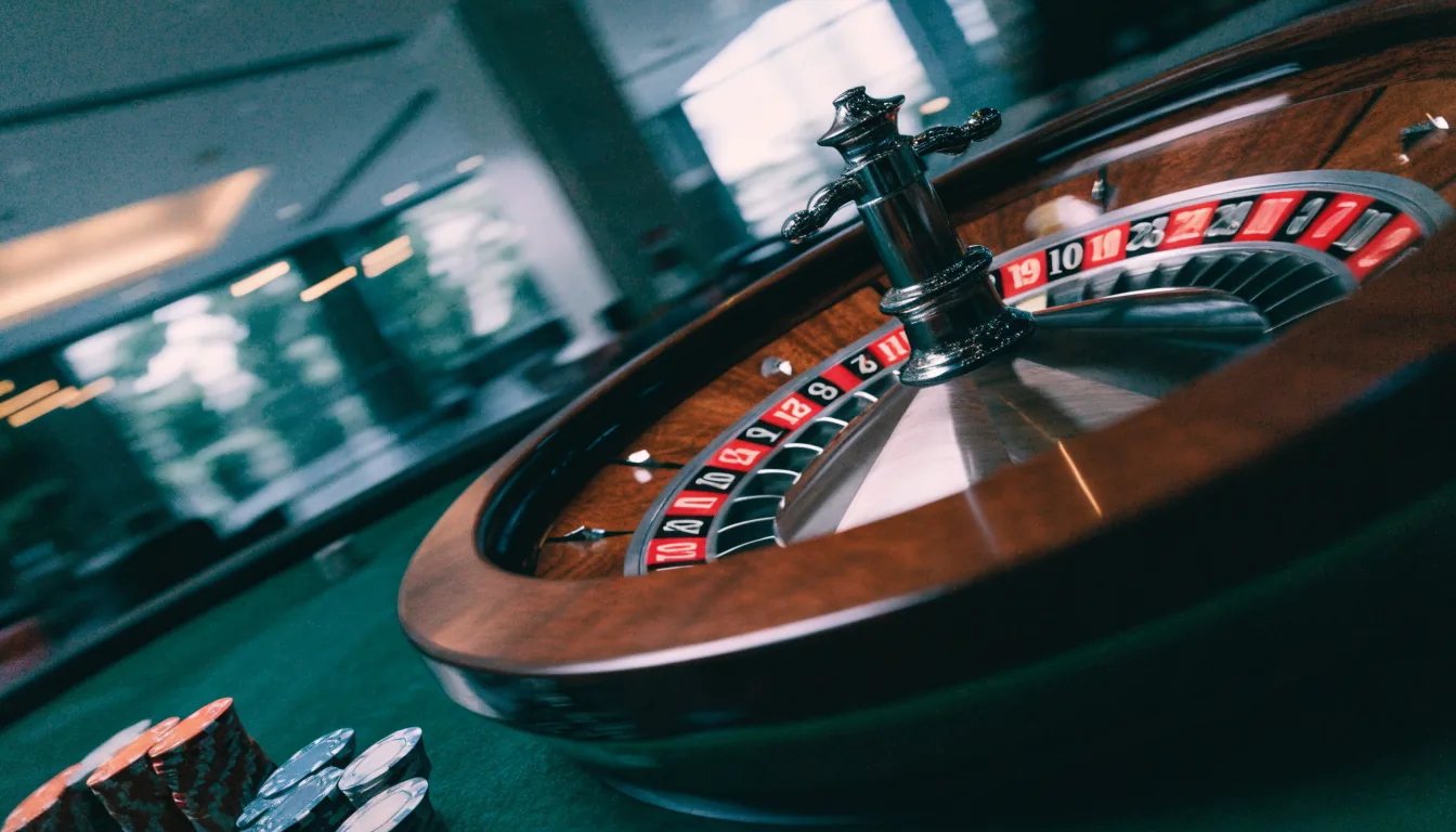 Spinning roulette wheel with motion blur on a green felt casino table